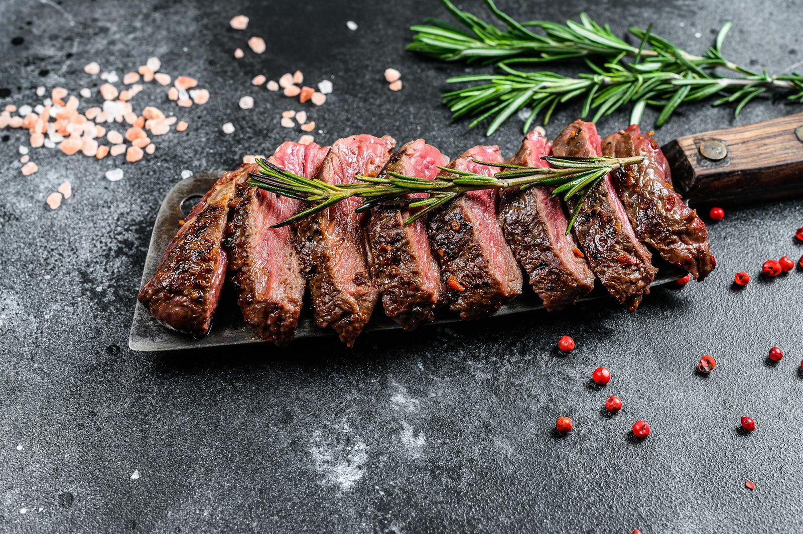 Grilled top blade, Denver steak. Marble meat beef. Black background. Top view