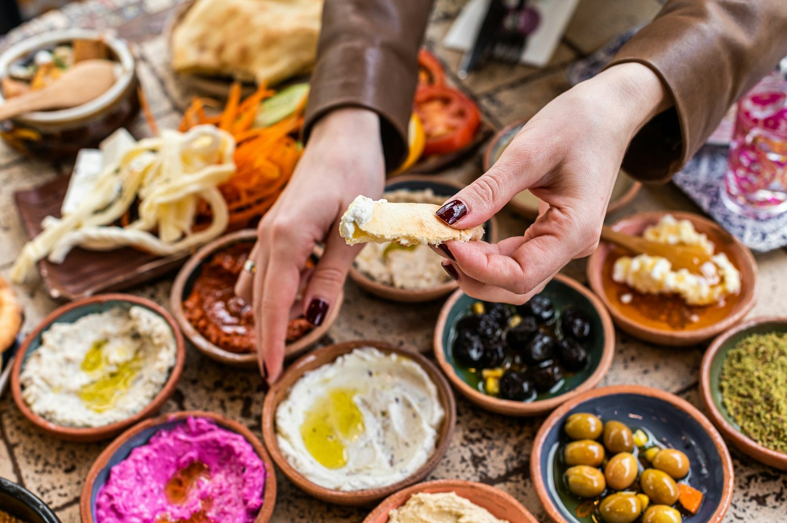 Women eating Traditional Turkish Village Breakfast served in restaurant. Top view